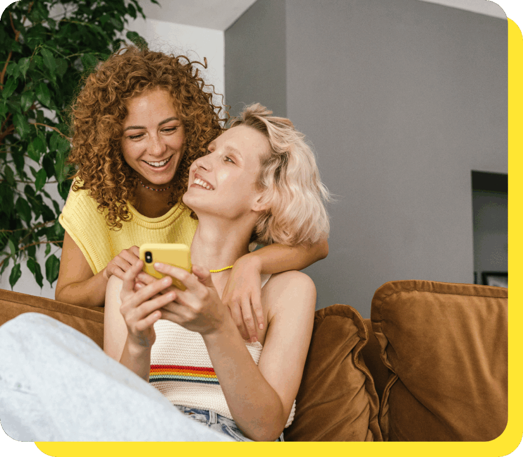 Happy couple smiling and celebrating their win from a prize-linked savings account.