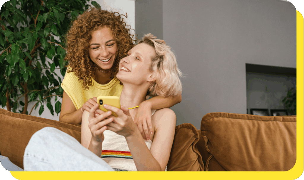 Happy couple smiling and celebrating their win from a prize-linked savings account.