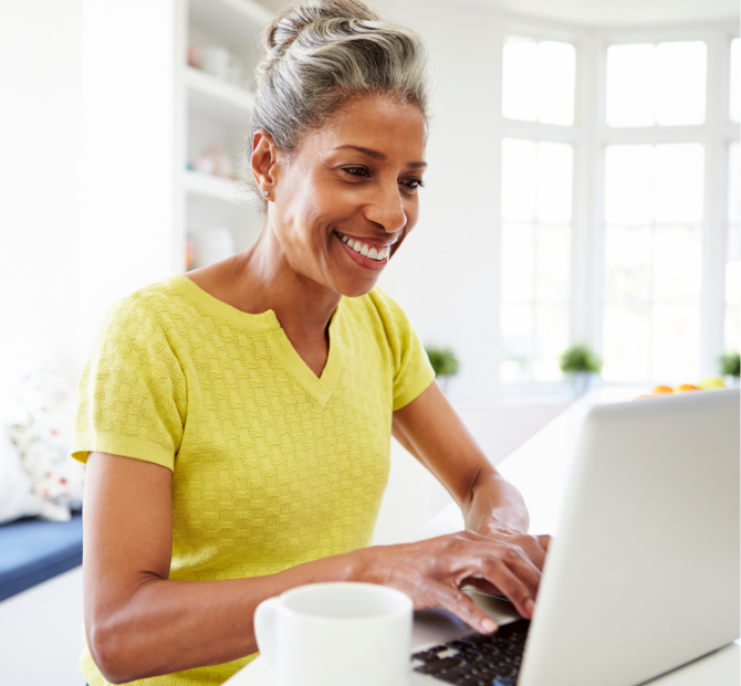 Woman using laptop to explore credit union loan calculator options