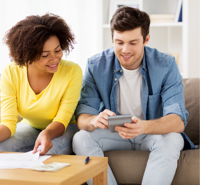 Couple reviewing figures with a credit union loan calculator