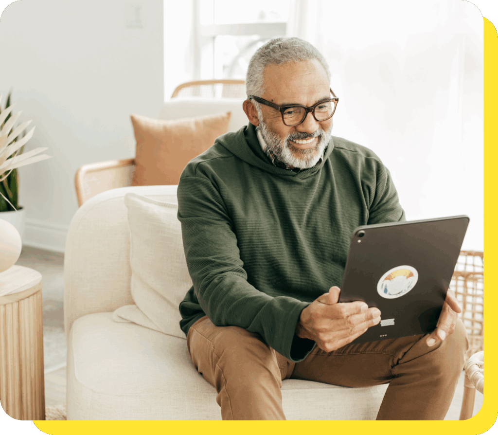 A man on a tablet calculating tax benefits for employees using a benefits calculator