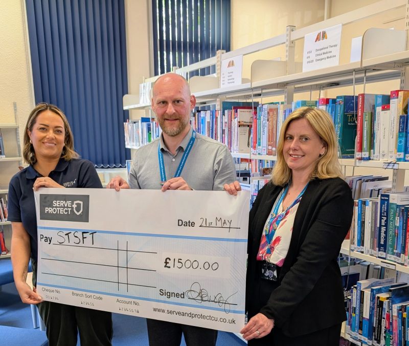 Serve and Protect Credit Union provide a cheque to fund the STSFT wellbeing library at South Tyneside District Hospital