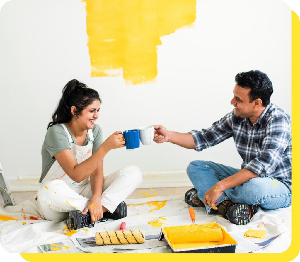 A happy couple cheersing mugs together, celebrating their successful home renovation funded by a Serve and Protect home improvement loan.
