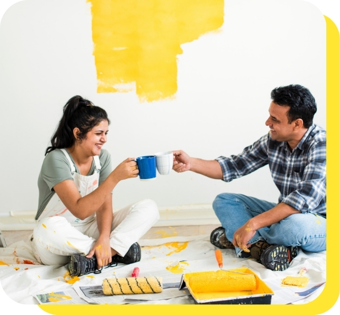 A happy couple cheersing mugs together, celebrating their successful home renovation funded by a Serve and Protect home improvement loan.