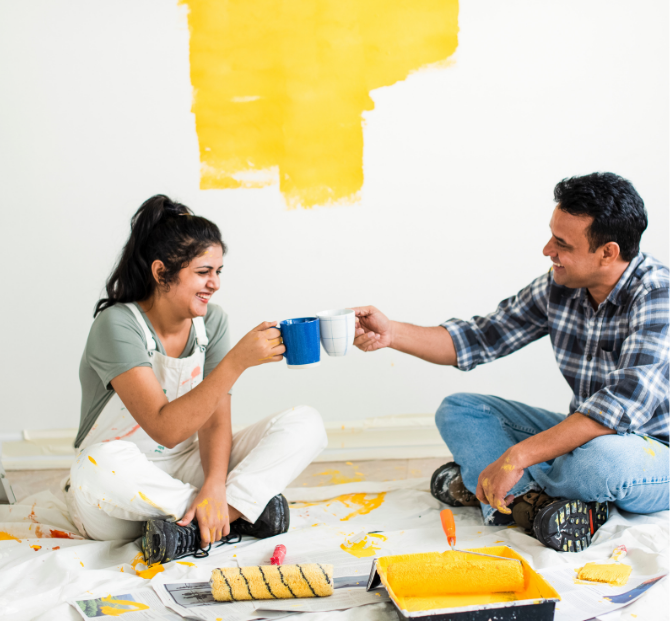 A happy couple cheersing mugs together, celebrating their successful home renovation funded by a Serve and Protect home improvement loan.