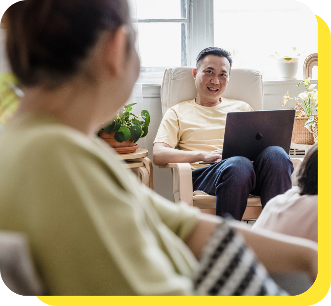 Smiling couple discussing tax benefits for employees, representing financial satisfaction and partnership support from their credit union