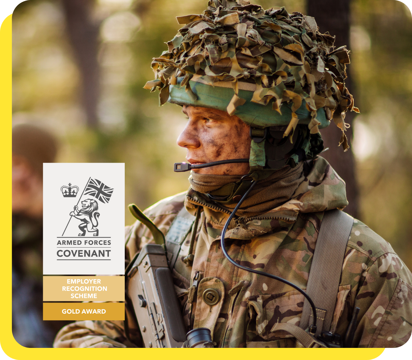 A proud soldier in uniform standing confidently with the Armed Forces Covenant Gold Award logo, representing the company's commitment as an armed forces-friendly employer.
