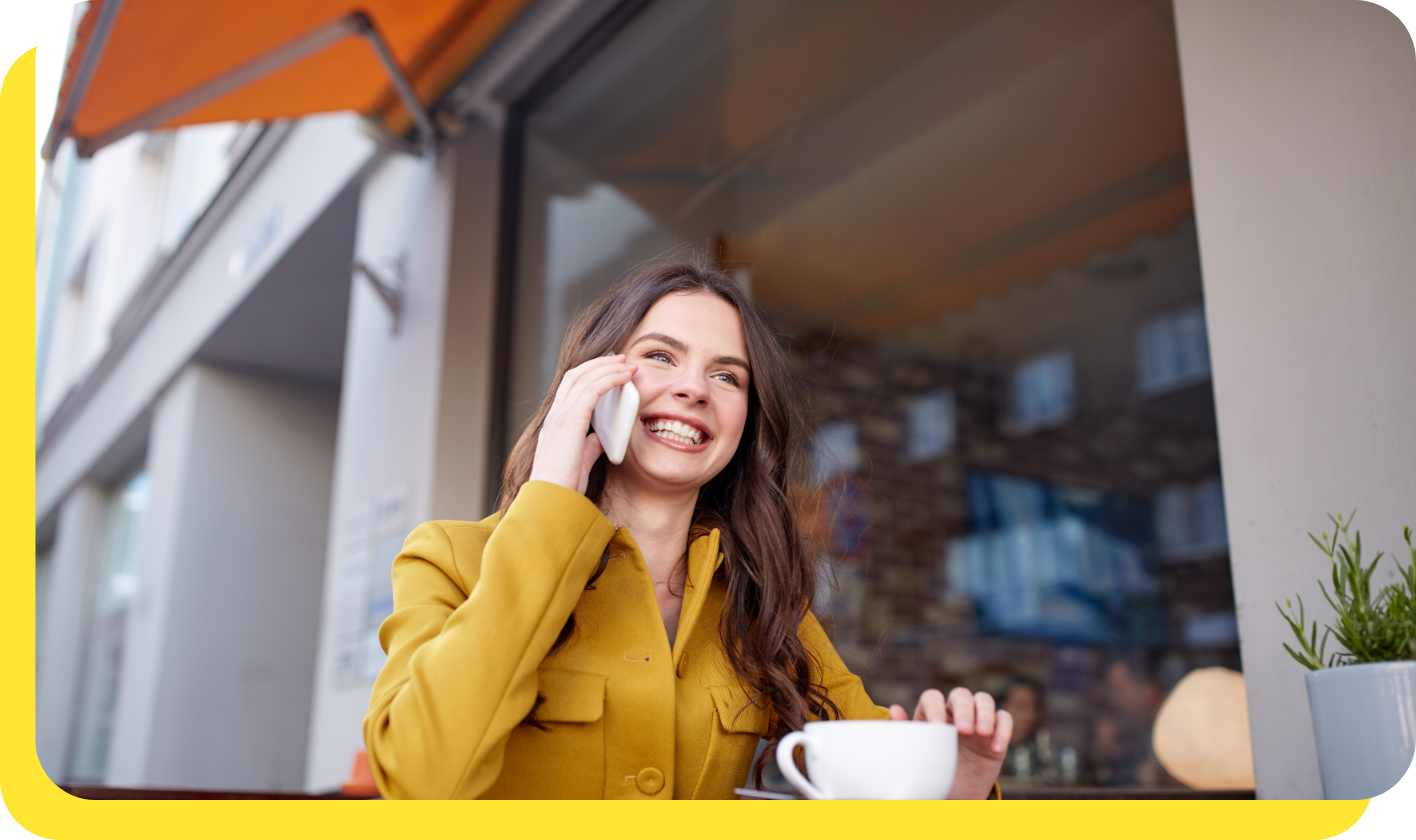 Happy woman smiling whilst calling Serve and Protect Credit Union's friendly customer support team for assistance.