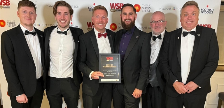 Six members of the Serve and Protect Credit Union team stand with their award as Highly Commended in Financial Education Provider of the Year at the WSB Awards 2025
