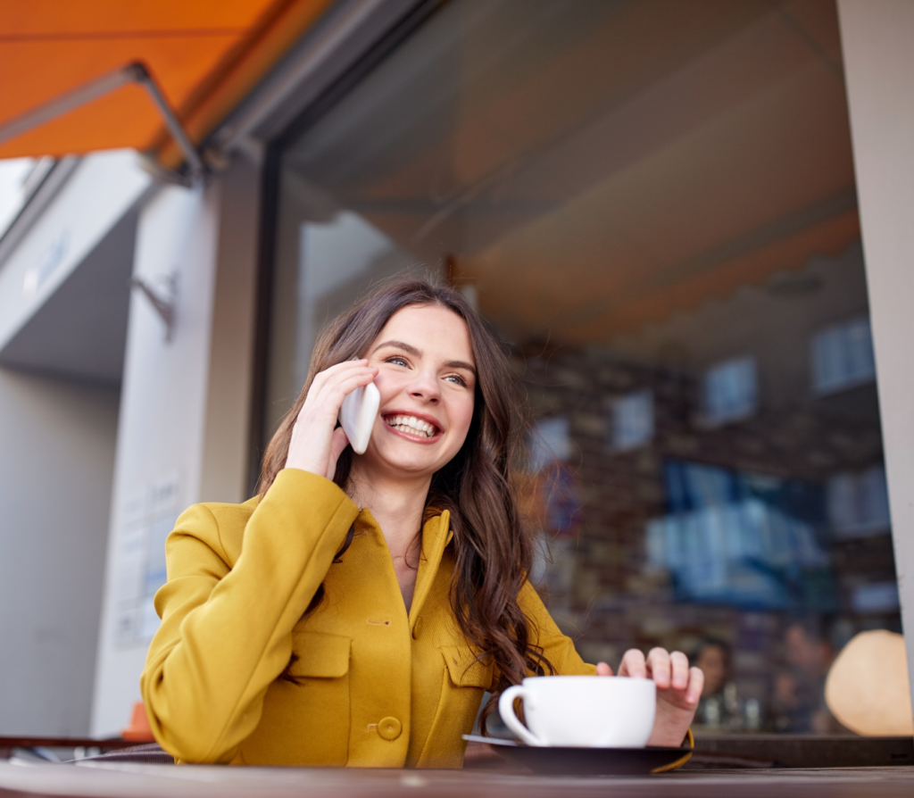 Happy woman on the phone receiving support and asking questions about credit union loans.