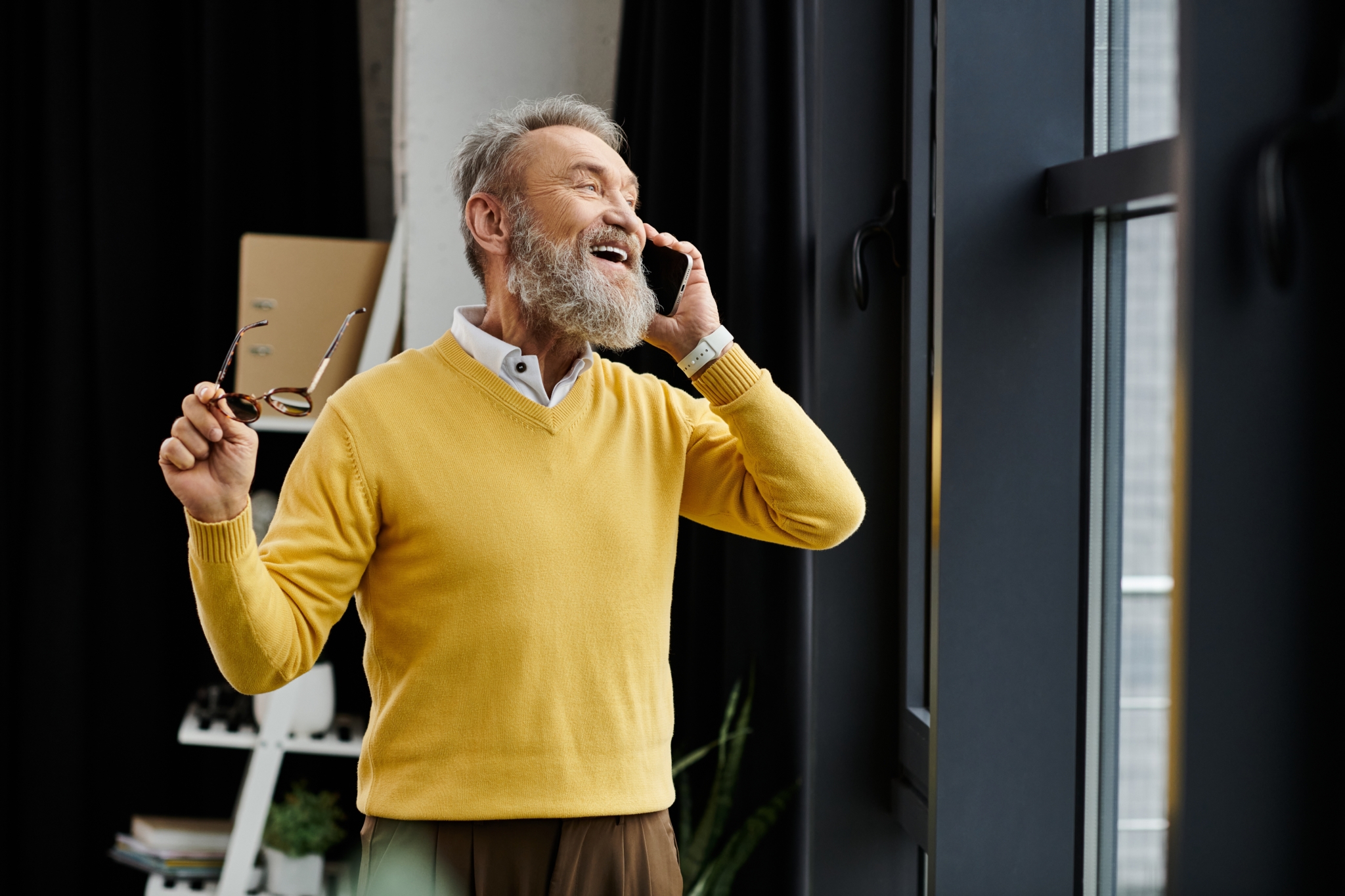 Handsome Senior Man Dressed In A Yellow Sweater Smiles While