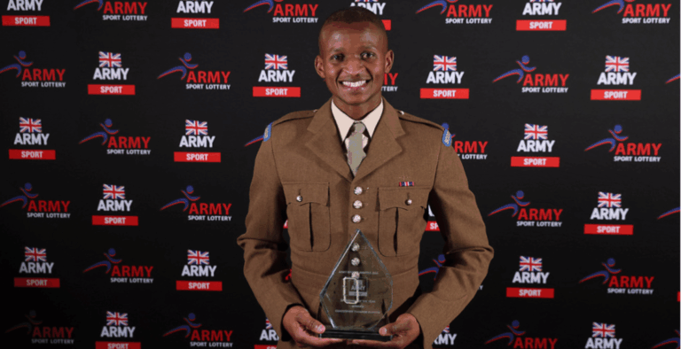 Thandor with a trophy, showcasing the success that comes from workplace resilience and employee financial wellbeing support.