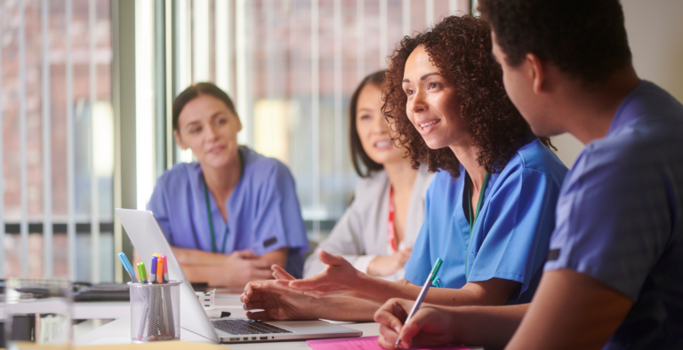 Healthcare professionals in a meeting discussing staff benefits; an example of the public sector workforce that benefits from ethical financial partnerships.