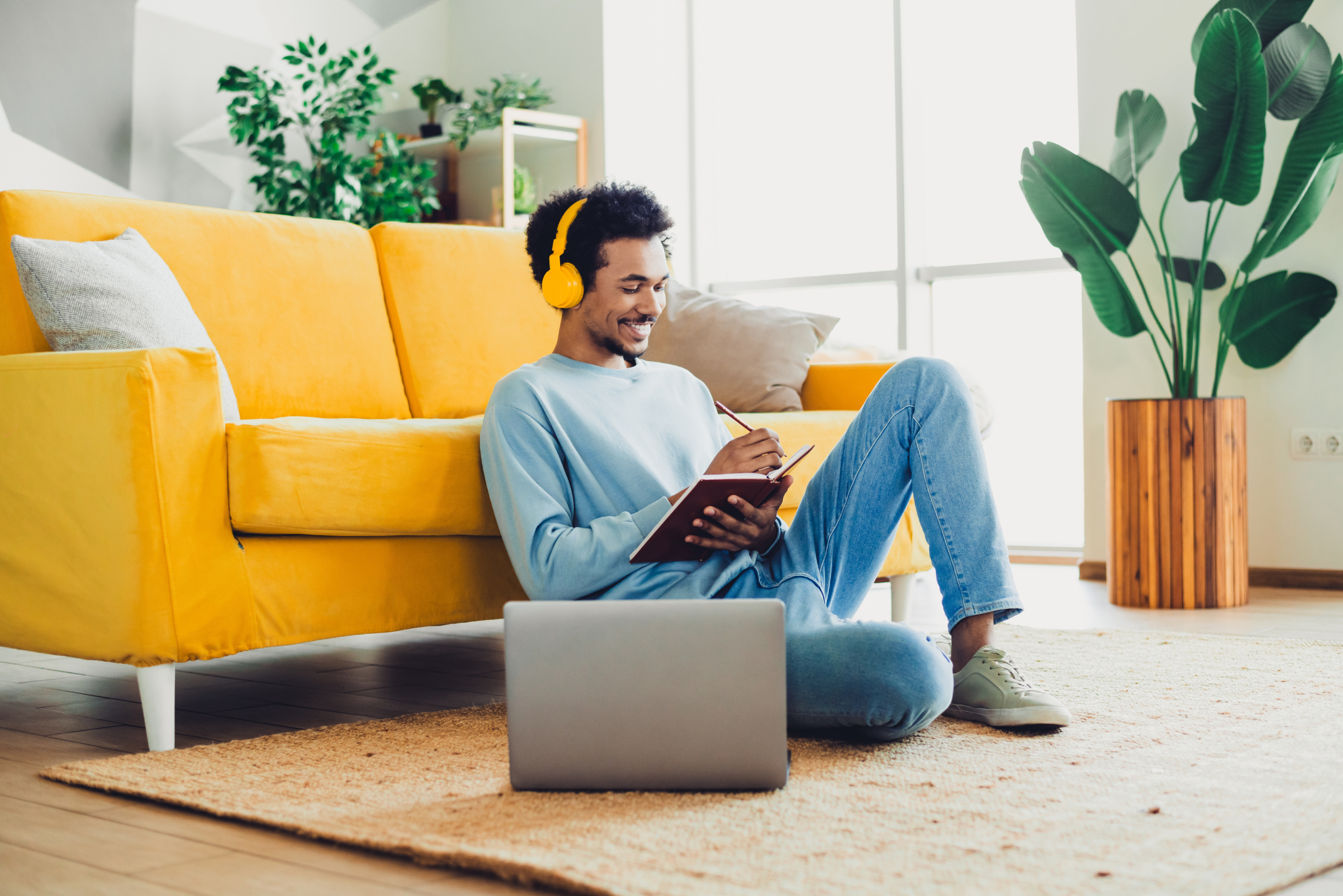 Man smiling at his phone while seated, enjoying Workplace Savings.