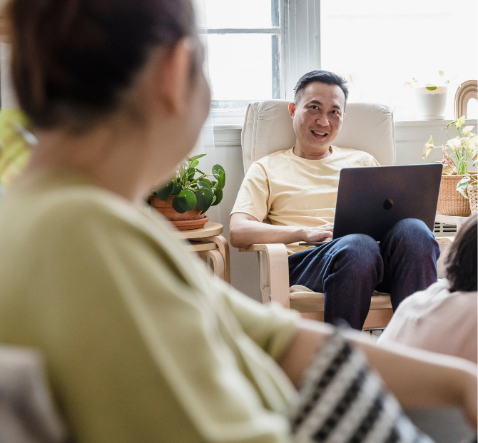Smiling man using laptop to review tax benefits for employees