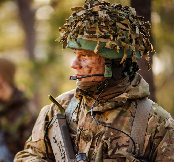 A proud soldier in uniform standing confidently, representing the company's commitment as an armed forces-friendly employer.