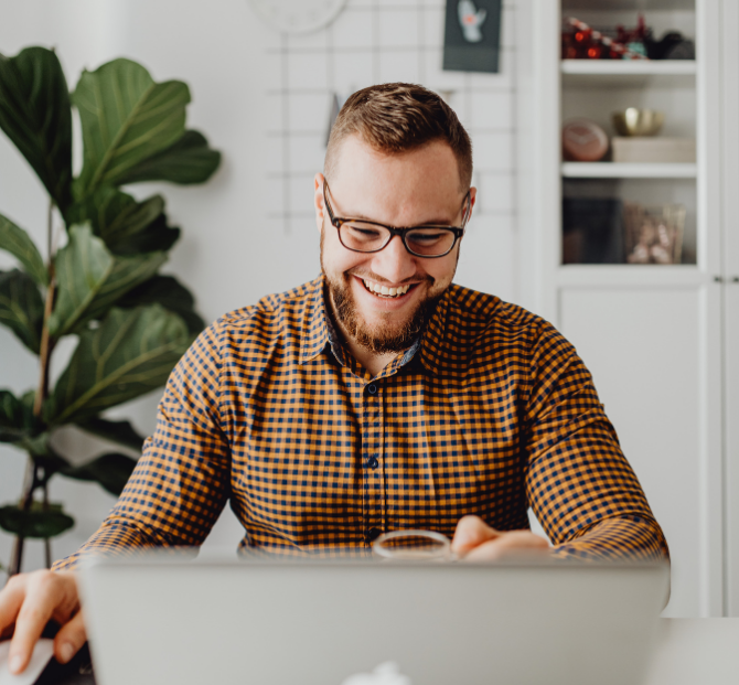 Employee smiling while reviewing workplace savings online.