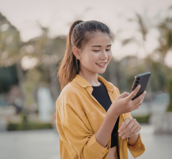 Woman on the phone using an immigration fee calculator to plan application costs