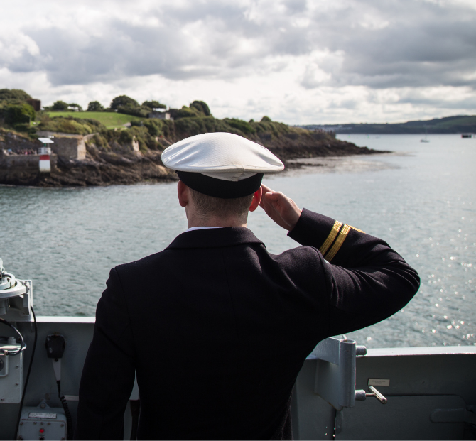 Back of a navy officer planning moving expenses with a relocation cost calculator