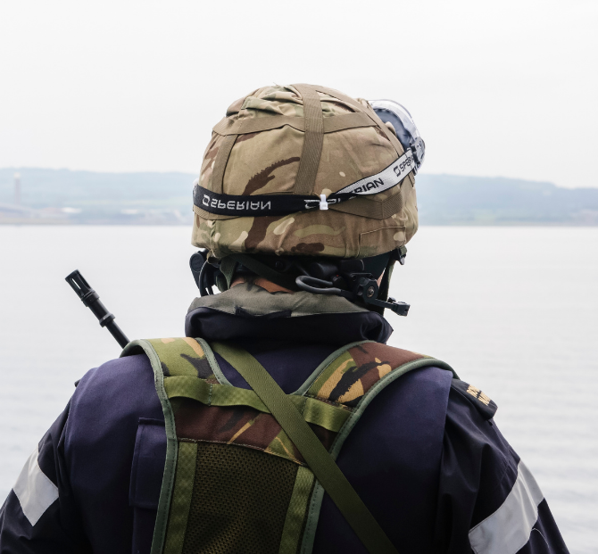 Back of a soldier preparing for a move with a relocation cost calculator