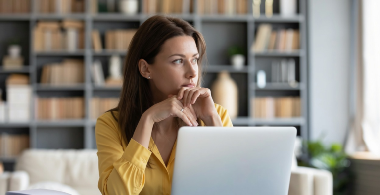 Person using a laptop for an article about ADHD and money management